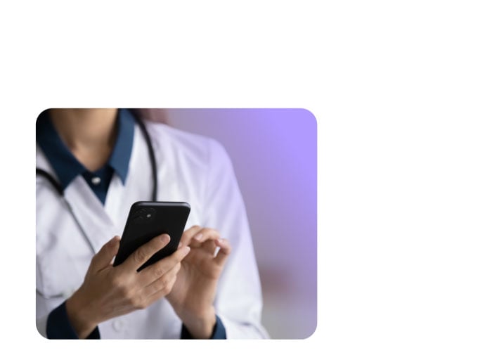 A health professional looking at her phone