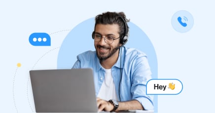 A sales representativ smiling and looking at his laptop