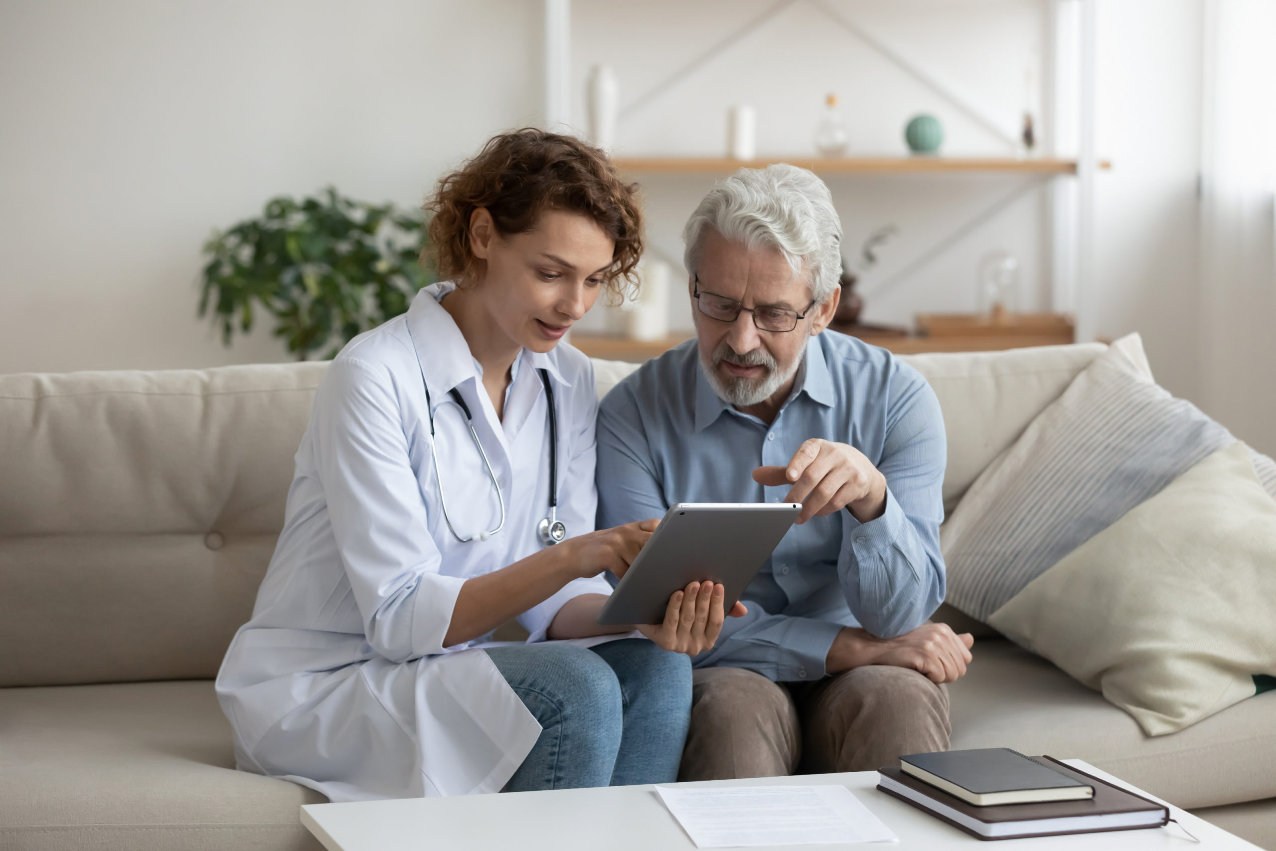 a nurse and a patient looking at a tablet